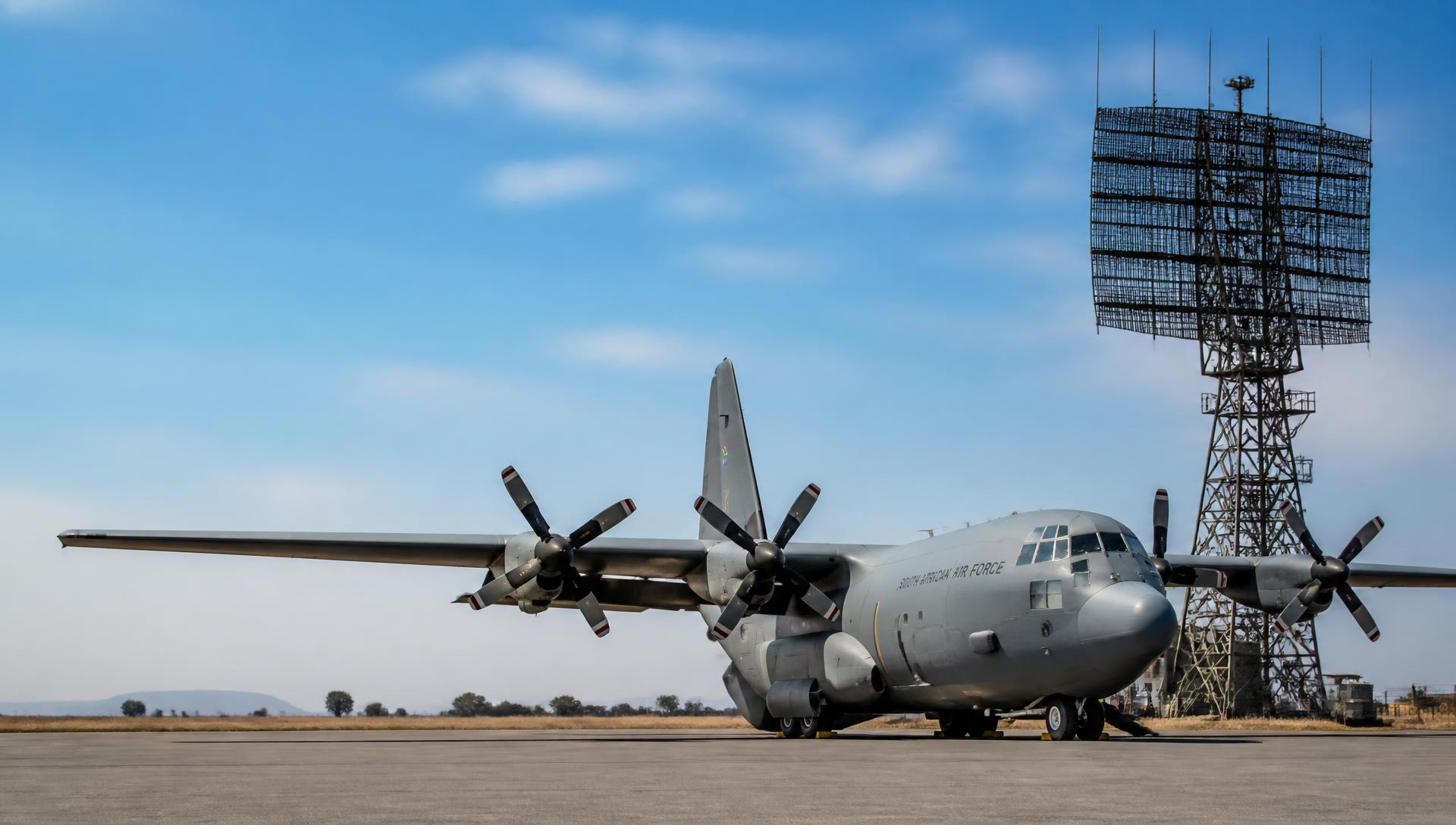 Military transport aircraft and radar installation at dusk over the African horizon